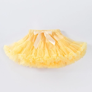 Detail of yellow tulle tutu skirt with a large satin bow and elastic waistband