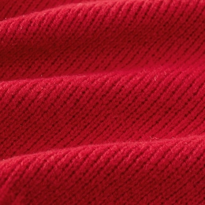 Close-up of high-quality red thick knit fabric showing soft texture and warm wool yarn