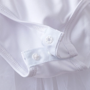 Detail of white long-sleeve ballet tutu bodysuit with snap buttons and mesh fabric