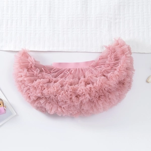 Detailed view of pink multilayered tulle tutu skirt with elastic waistband and ribbon bow