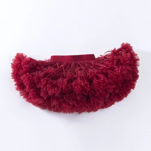 Detailed view of layered burgundy tulle tutu skirt with elastic waistband and ribbon bow