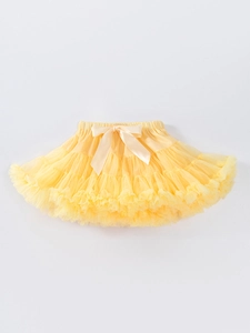Bright yellow multi-layered girls tutu skirt with a large satin bow for Halloween