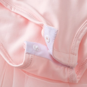 Close-up of secure snap buttons on the crotch of a pink cotton ballet tutu romper