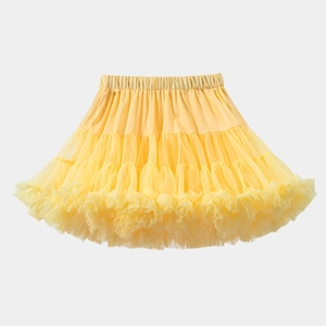 Detail of yellow multi-layered tutu skirt showing ruffled tulle texture and elastic waistband