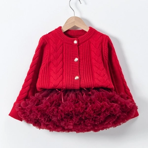 Detail of red cable-knit cardigan with heart patterns and layered wine red tutu skirt
