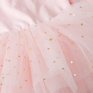 Detail of pink tutu skirt featuring golden star and moon sequins on soft mesh layers