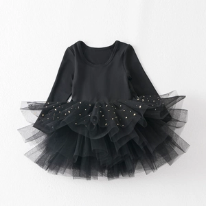 Detail of long sleeve tutu dress with gold star and moon sequins on black mesh skirt
