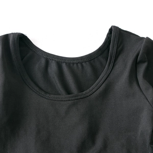 Detailed macro shot of the durable double-stitched neckline on a black ballet tutu dress