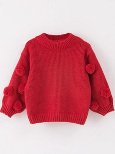 Kids red knit sweater with playful pompom accents and cozy ribbed cuffs for winter