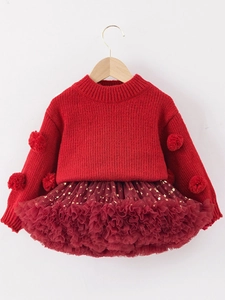 Festive girl's red knit sweater with pom-poms and gold star tutu skirt set