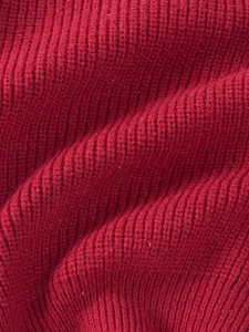 Macro shot of dark red ribbed knit fabric with subtle glitter fibers for tutu skirts