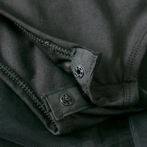 Detail view of the secure snap button closure on black long sleeve ballet tutu dress