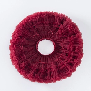 Detailed flat lay of burgundy multi-layer tulle tutu skirt with small ribbon bows