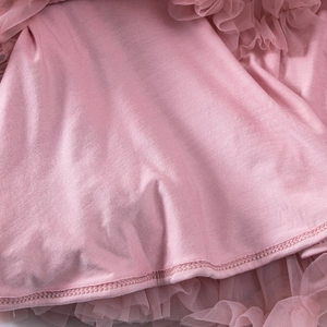 Close-up of pink tulle layers and smooth lining on children tutu skirt