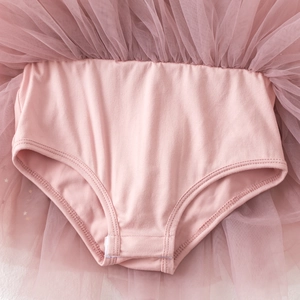Detail view of pink baby ballet tutu romper showing cotton fabric and snap buttons