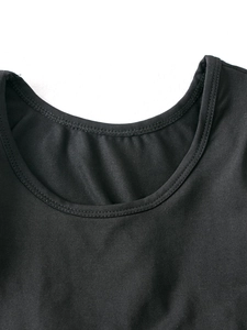 Close-up of black long-sleeve ballet dress with a U-neckline and fine ribbed texture