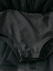 Detailed view of black ballet tutu dress with elastic fabric and reinforced stitching