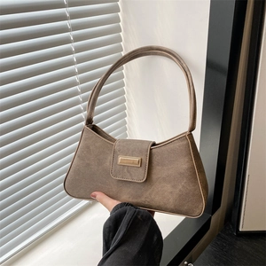 Vintage brown canvas baguette shoulder bag featuring a gold rectangular metal clasp