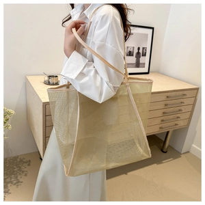 Detail of elegant gold mesh tote bag showing the fine semi-transparent fabric and texture