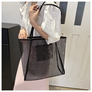 Detail view of large black mesh tote bag showing internal pocket and mesh texture