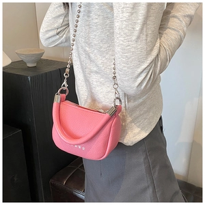 Mini pink saddle bag with lychee grain leather texture and metallic bead chain strap