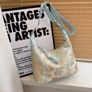 Elegant floral satin half-moon shoulder bag with light blue adjustable leather strap