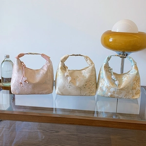 Elegant floral brocade handbags with metal handles in pink beige and blue tones