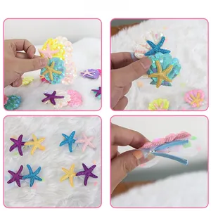 Detail view of sequined starfish and shell hair clips with mesh backing and metal clips