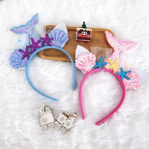 Detail of blue and pink mermaid headbands with sequins, shells and starfish for kids