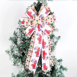 Patriotic USA Independence Day burlap bow with red truck and star patterns on tree