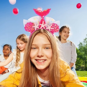 Close-up of pink mermaid tail headband with sequins and starfish for kids party
