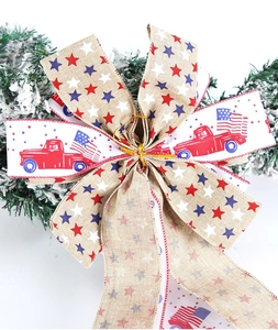 Detail of burlap Fourth of July bow with vintage truck and star patterns on a wreath