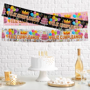 Colorful Macaron FELIZ CUMPLEAÑOS party banners set against a white brick wall background