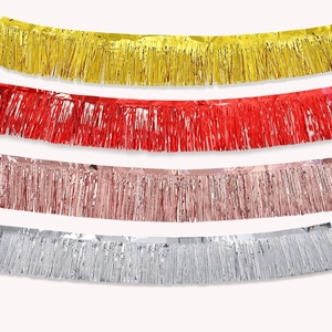 Macro view of metallic tinsel fringe garland in gold red and silver for party decor