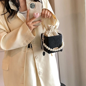Elegant black pleated bucket bag with pearl handle and golden chain strap for women