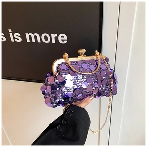 Detail of purple sequin evening clutch bag with gold vintage metal clasp and chain
