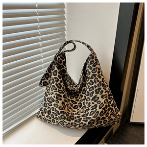 Detail of hobo bag with classic leopard print pattern against shutters