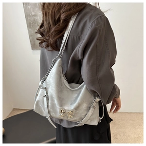 Détail du sac hobo métallisé argent avec boucle en métal et bandoulières réglables