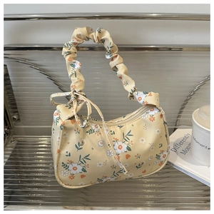Detail of floral shoulder bag showing yellow daisy print and scrunchie handle design
