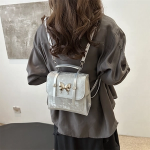 Silver butterfly mini backpack for women with metallic finish shown on model back