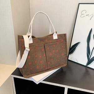 Brown corduroy strawberry tote bag with double pockets and adjustable shoulder strap