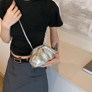 Silver metallic ruched cloud bag with adjustable crossbody strap shown on model