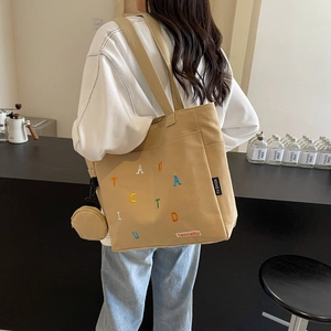 Beige large capacity canvas tote bag with embroidered letters and mini pouch charm