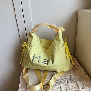 Light yellow nylon tote bag with Hai embroidery and adjustable shoulder strap for daily use