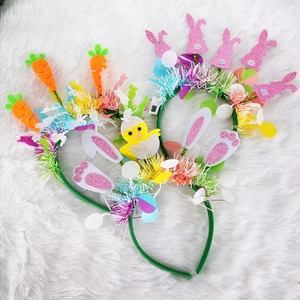 Easter bunny and carrot headbands with colorful tinsel on a white faux fur background