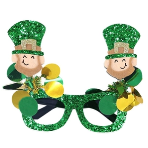 Green glittery St. Patrick's Day glasses with leprechaun toppers and golden coins