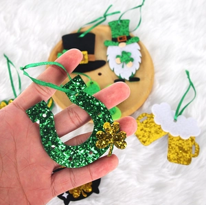 Green glittery St. Patrick's Day gnomes and shamrock felt ornaments on a ribbon
