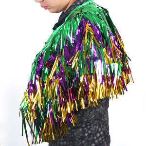 Detailed layers of green, purple and gold metallic foil fringe on a festival shawl