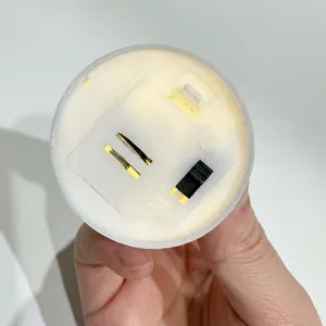 Bottom view of LED electronic candle showing power toggle switch and battery compartment
