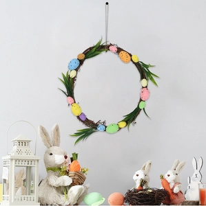 Close-up of Easter wreath with colorful foam eggs and green leaves on a rustic twig base